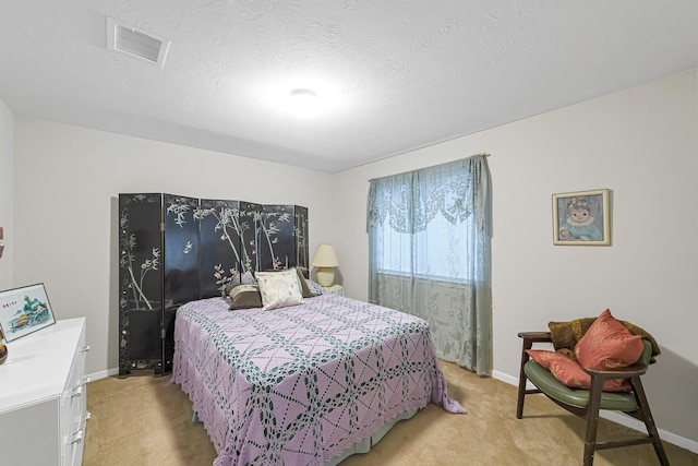 carpeted bedroom with a textured ceiling