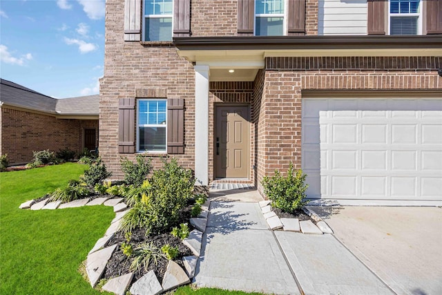 doorway to property featuring a yard and a garage