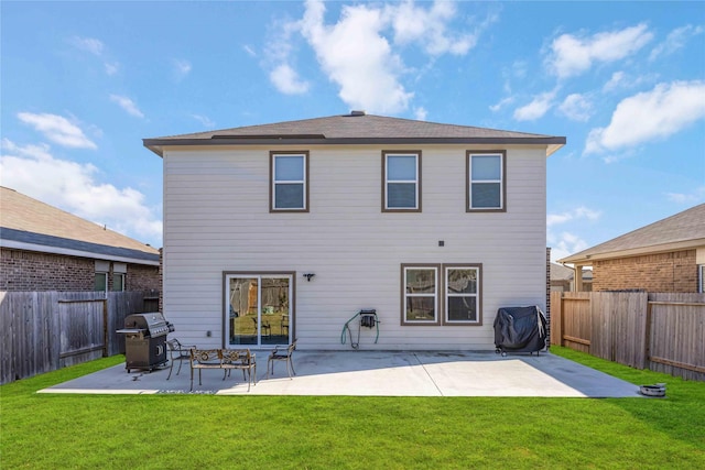 back of property featuring a yard and a patio