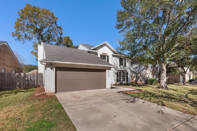 view of front facade with a front yard and a garage