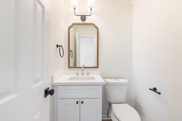 bathroom featuring toilet and vanity