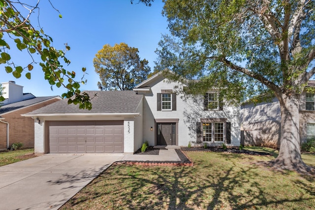 view of front facade featuring a front lawn and a garage