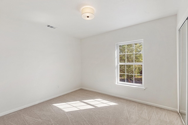 empty room with light colored carpet