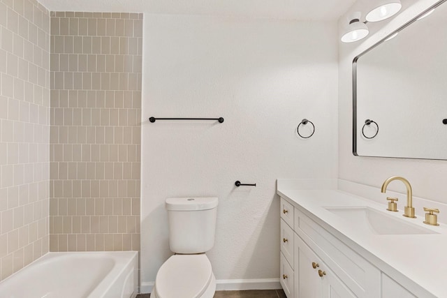 full bathroom featuring toilet, tiled shower / bath, and vanity