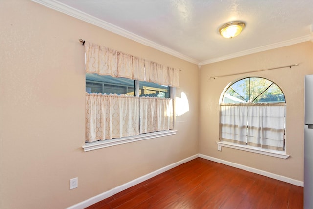 empty room featuring ornamental molding and dark hardwood / wood-style floors