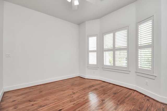 spare room with ceiling fan and hardwood / wood-style floors