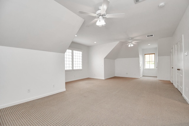 additional living space featuring vaulted ceiling, ceiling fan, and light carpet