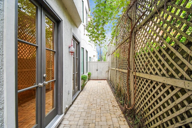 view of side of property with french doors and a patio area