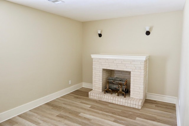 unfurnished living room featuring light wood-type flooring and a fireplace