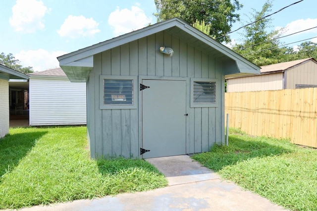 view of outbuilding featuring a yard