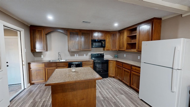 kitchen featuring a kitchen island, light hardwood / wood-style flooring, black appliances, and sink