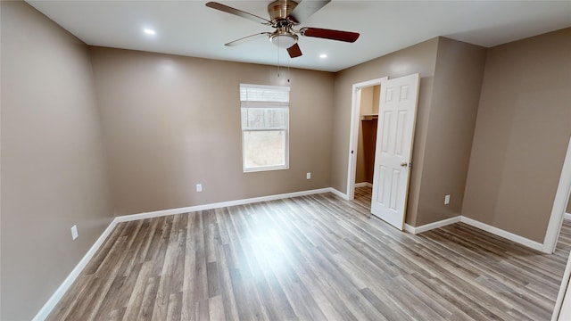 empty room featuring ceiling fan and light wood-type flooring