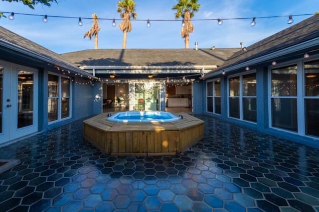 view of patio with an outdoor hot tub