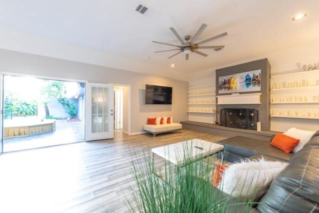 living room with french doors, ceiling fan, and hardwood / wood-style floors