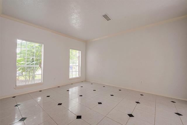 unfurnished room featuring ornamental molding and light tile patterned floors