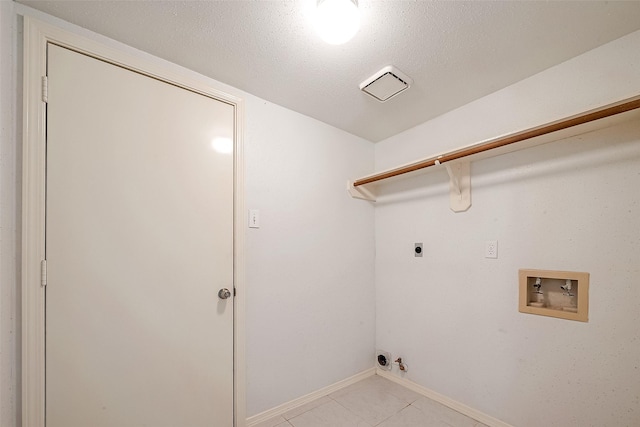 laundry area featuring a textured ceiling, hookup for a washing machine, hookup for a gas dryer, and hookup for an electric dryer