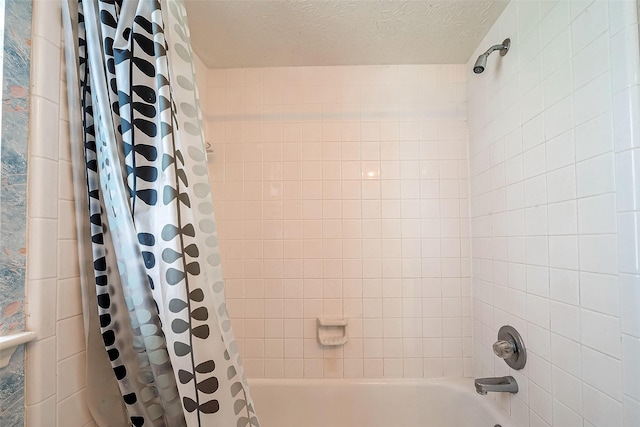 bathroom featuring a textured ceiling and shower / bath combo with shower curtain