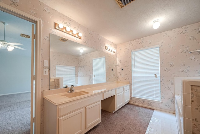 bathroom with a textured ceiling, ceiling fan, and vanity