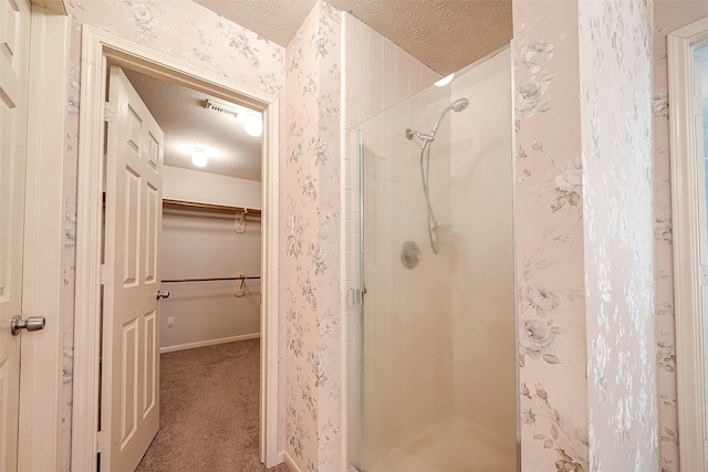 bathroom with an enclosed shower and a textured ceiling