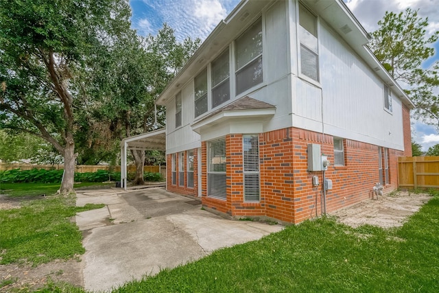 view of home's exterior featuring a lawn and a patio area