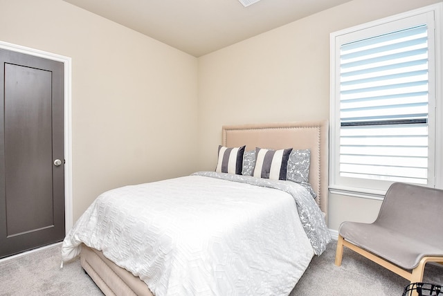 carpeted bedroom with multiple windows