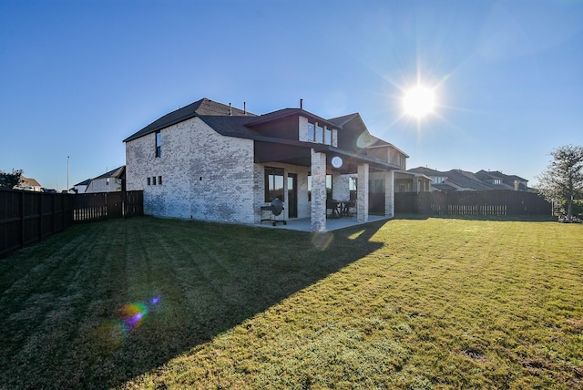 rear view of property with a patio area and a lawn