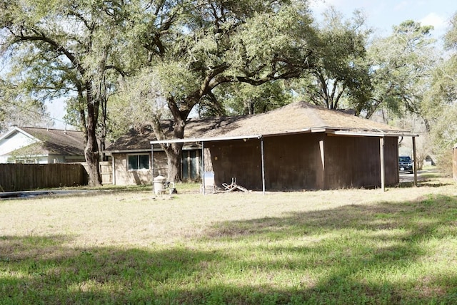 rear view of house with a yard