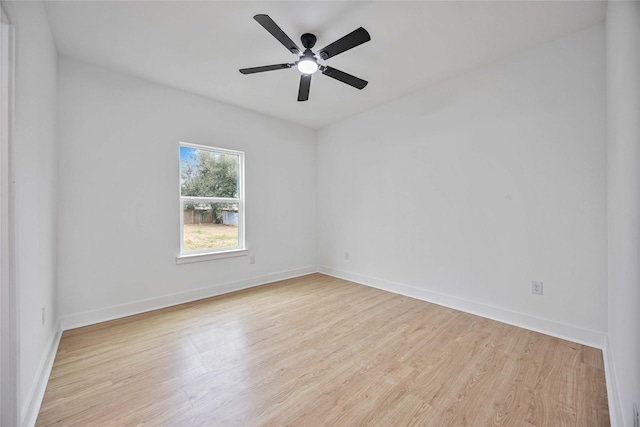 spare room with ceiling fan and light wood-type flooring