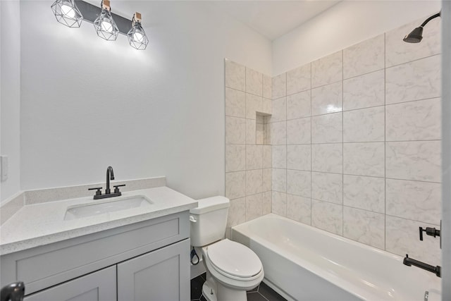 full bathroom featuring toilet, vanity, and tiled shower / bath