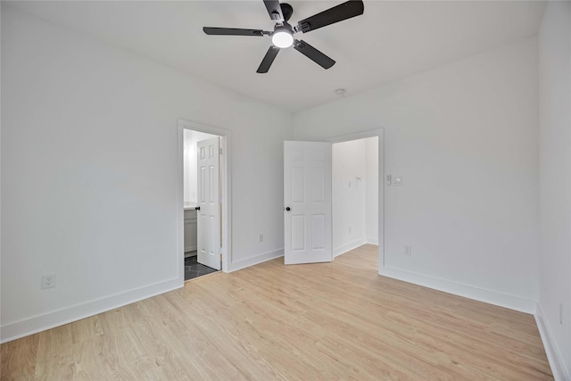 unfurnished bedroom featuring ensuite bath, ceiling fan, and light hardwood / wood-style flooring