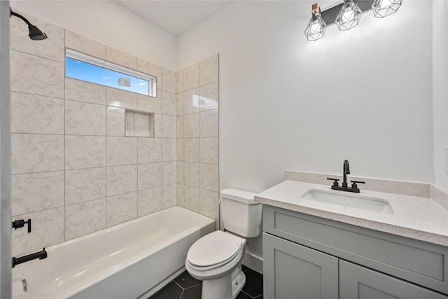 full bathroom with vanity, tiled shower / bath, tile patterned floors, and toilet