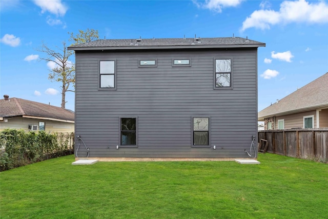 rear view of property with a lawn