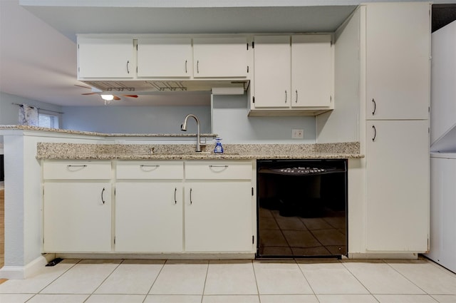 kitchen featuring white cabinets, black dishwasher, and light stone counters