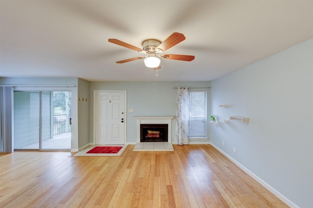 unfurnished living room featuring ceiling fan and light wood-type flooring