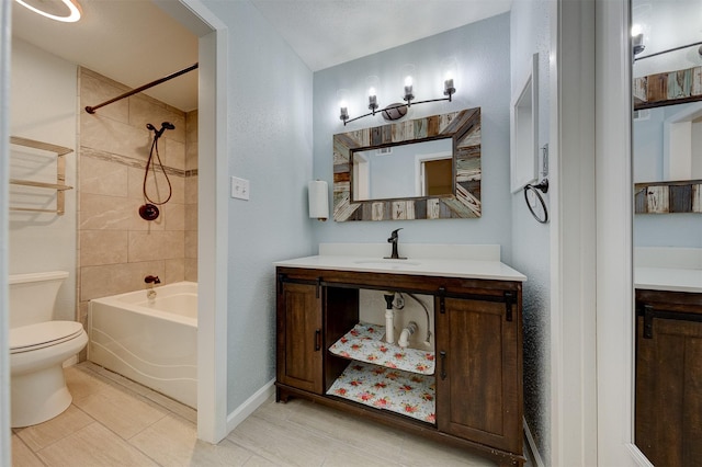 full bathroom with toilet, tiled shower / bath combo, tile patterned flooring, and vanity