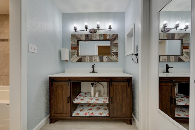 bathroom with tile patterned flooring and vanity