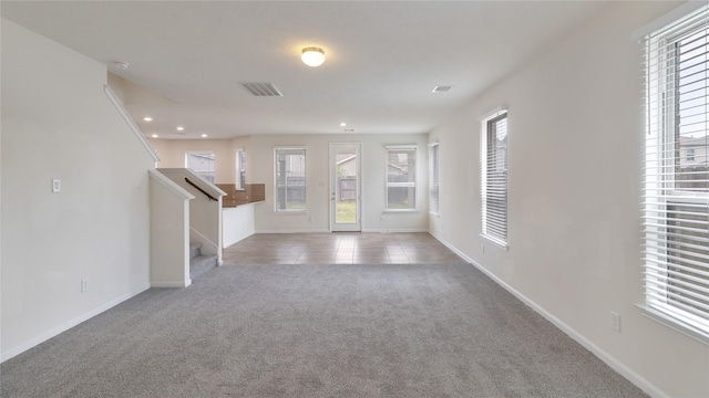 foyer featuring light carpet