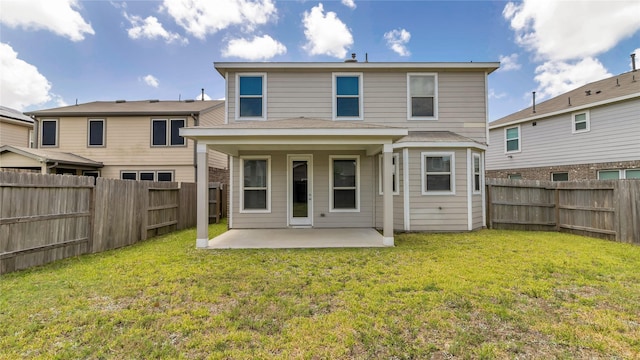 rear view of property featuring a patio and a yard