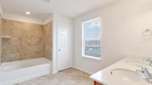 bathroom featuring tiled shower / bath combo, tile patterned flooring, vanity, and plenty of natural light