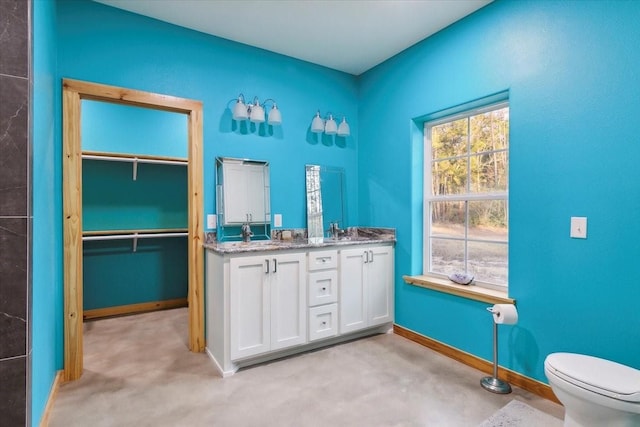 bathroom featuring toilet and vanity