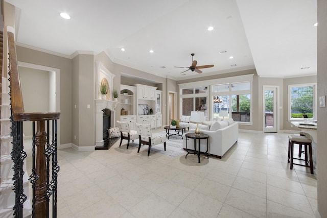 living room with ceiling fan, ornamental molding, and built in shelves