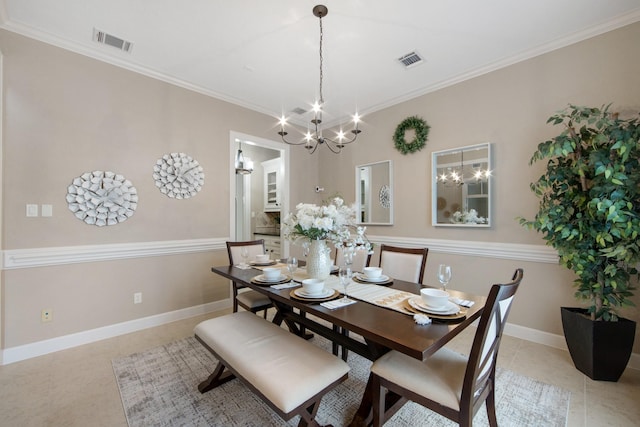 dining area with crown molding, a chandelier, and light tile patterned flooring