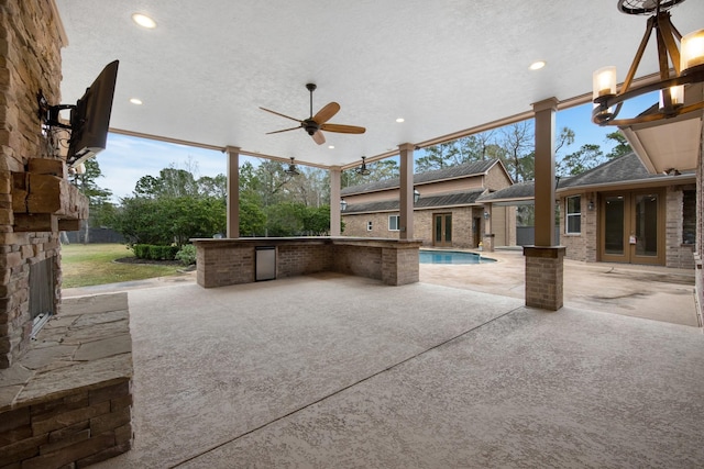 view of patio / terrace featuring ceiling fan and french doors