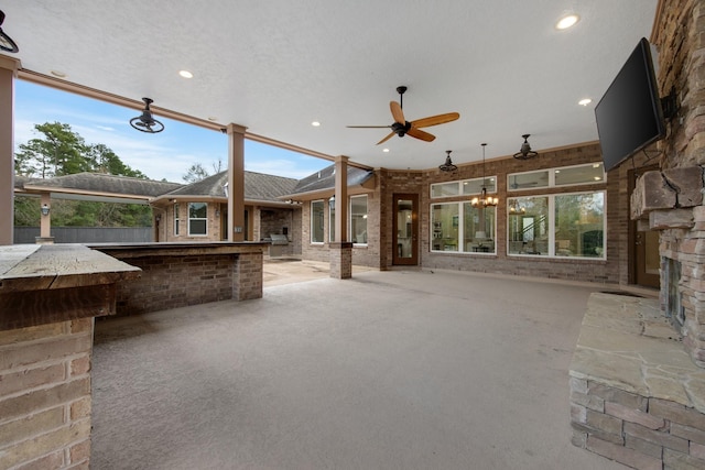 view of patio with ceiling fan and an outdoor bar