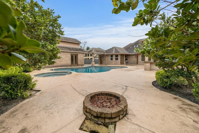 view of swimming pool with a patio area and an in ground hot tub