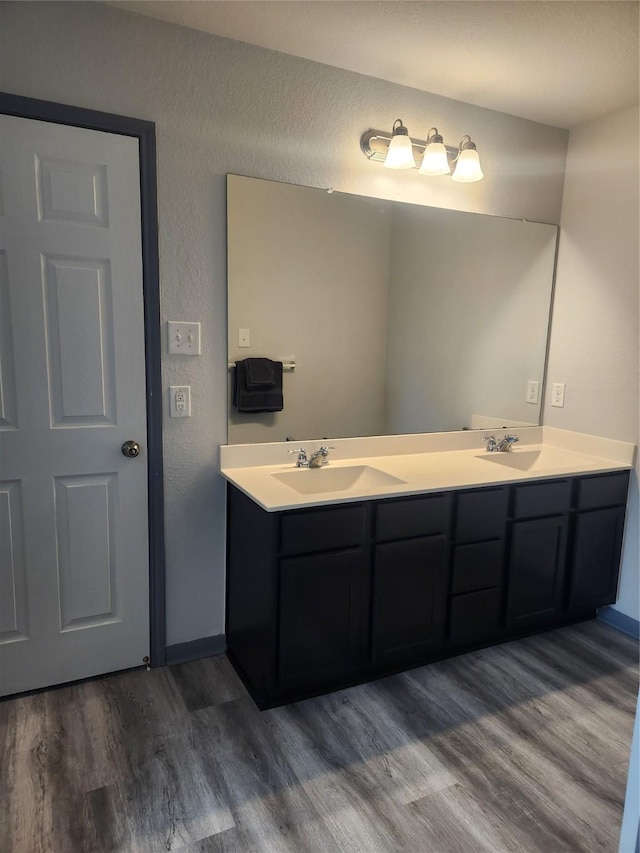 bathroom with vanity and hardwood / wood-style floors