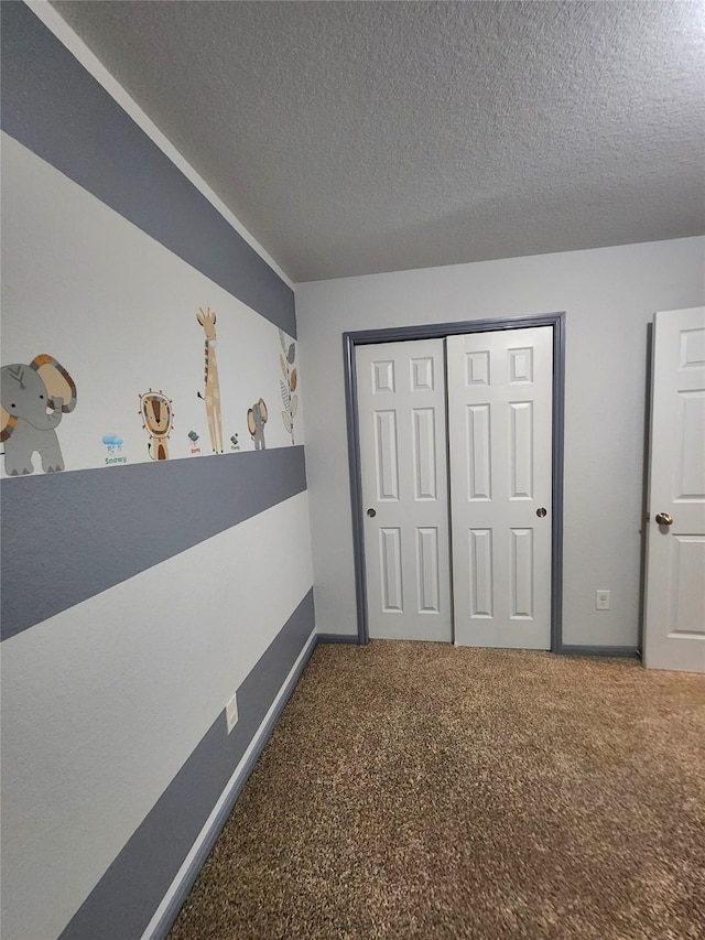 unfurnished bedroom with a closet, a textured ceiling, and carpet flooring