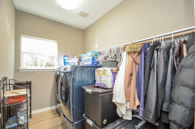 laundry room with independent washer and dryer and wood-type flooring