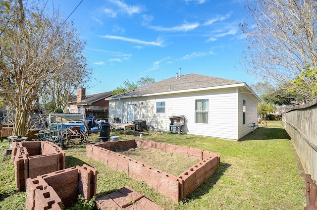 rear view of property featuring central AC and a lawn