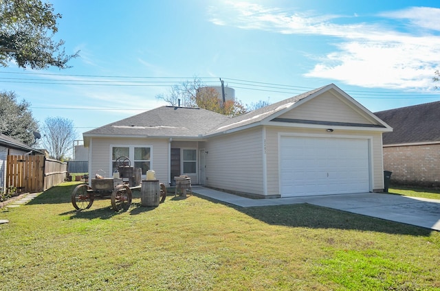 rear view of property with a garage and a lawn